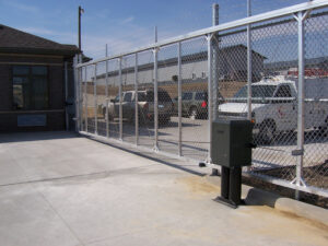 Large chainlink gate with trucks waiting behind